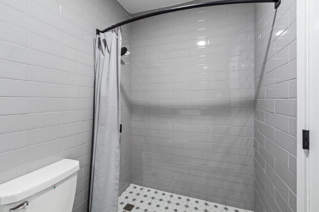 a bathroom with a shower and a toilet